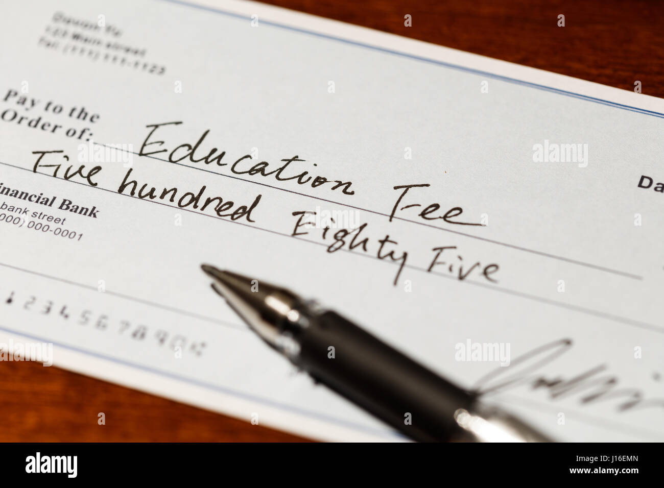 Fake cheque,  cheque for education fee, financial concept. Stock Photo