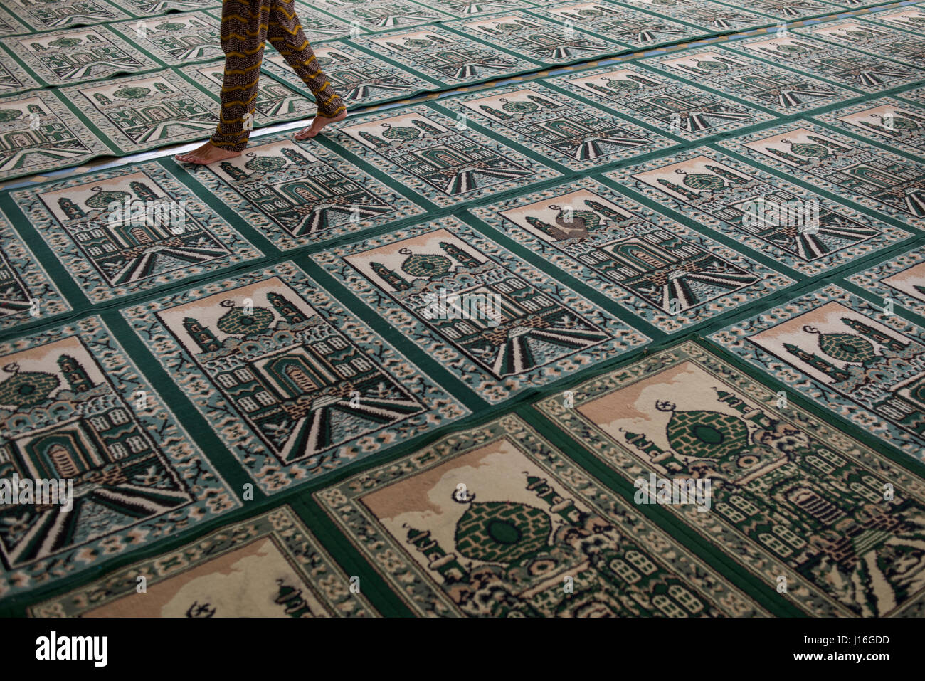 A Person Walking On Top Of Muslim Praying Carpet Inside The Grand Mosque, Medan, Sumatra, Indonesia Stock Photo