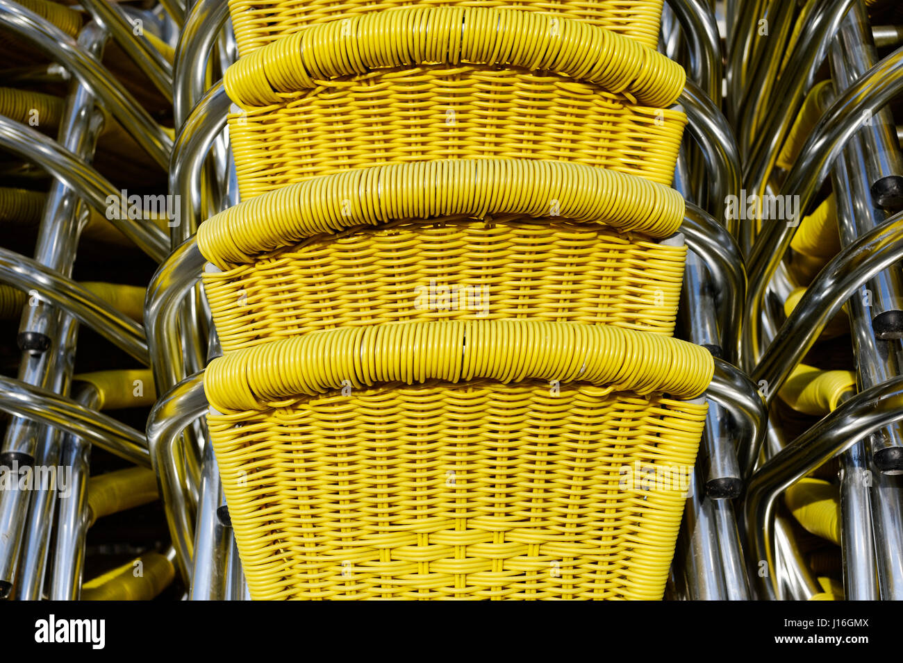 Backgrounds and textures stack of yellow wicker chairs at San Marco