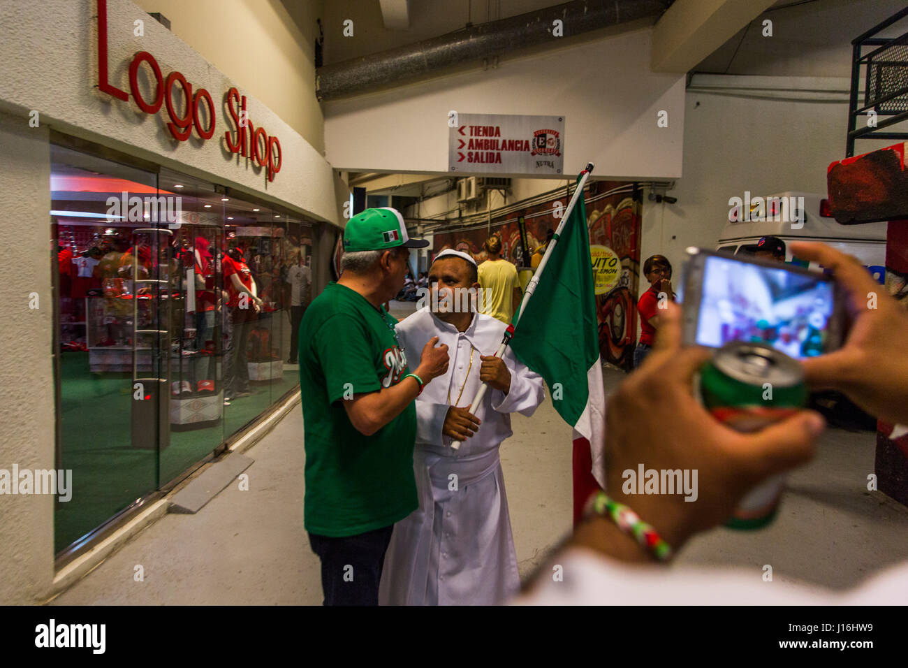 A Man Dressed As A Priest Holding A Mexican Flag In A Stadium Hallway In The Dominican Republic Stock Photo