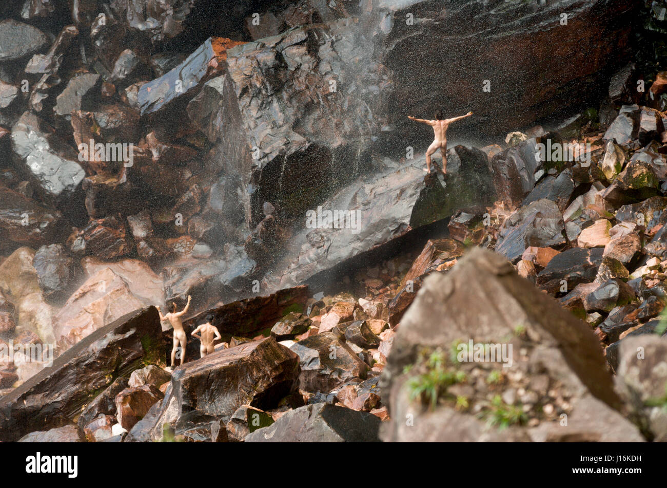 Three People Showering In A Waterfall In Venezuela Stock Photo Alamy