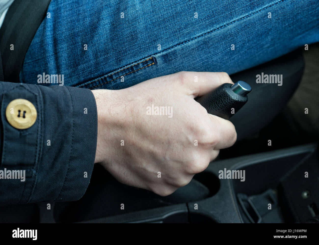driver pulling the hand brake in car Stock Photo Alamy