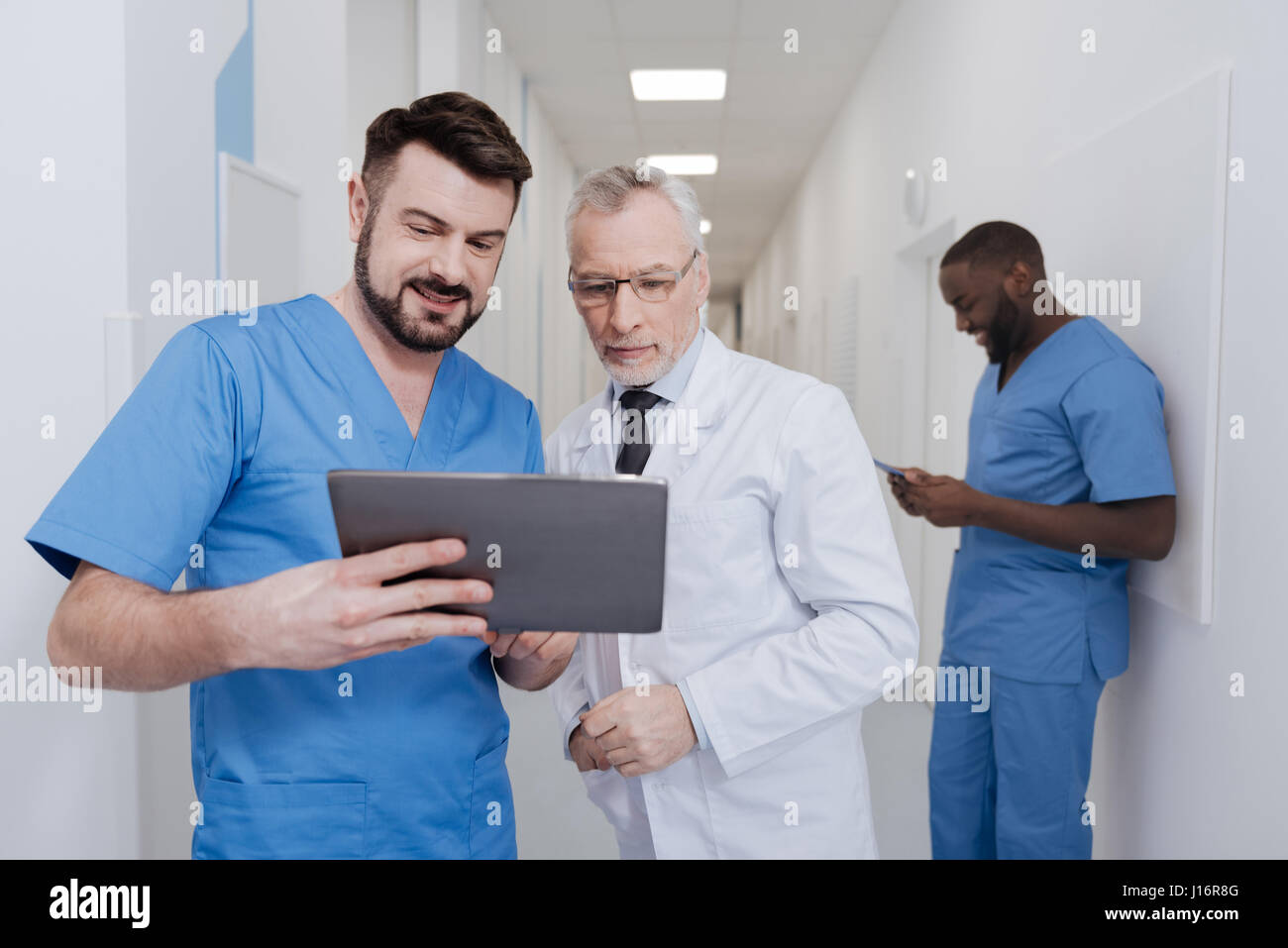 Curious medics using new device in the hospital Stock Photo