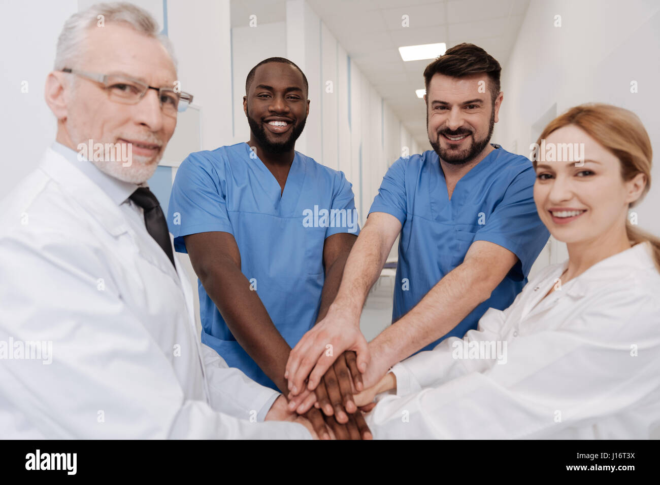 Positive medics practicing teambuilding in the hospital Stock Photo
