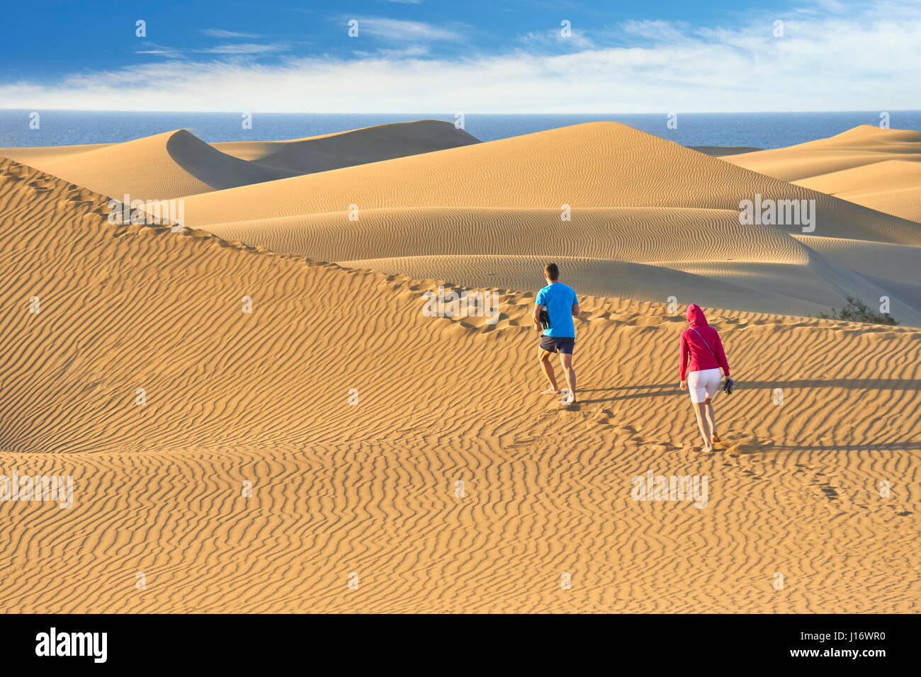 Tourists on the Maspalomas Sand Dunes National Park, Canary Islands, Gran Canaria, Spain Stock Photo