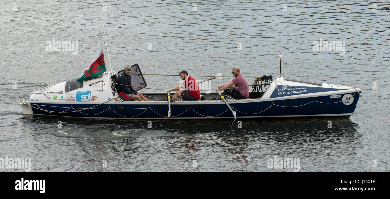 Talisker Whiskey Atlantic Challenge boat with crew. Rowers and coach training for Atlantic crossing onboard ocean-going rowing boat on lake in Cardiff Stock Photo