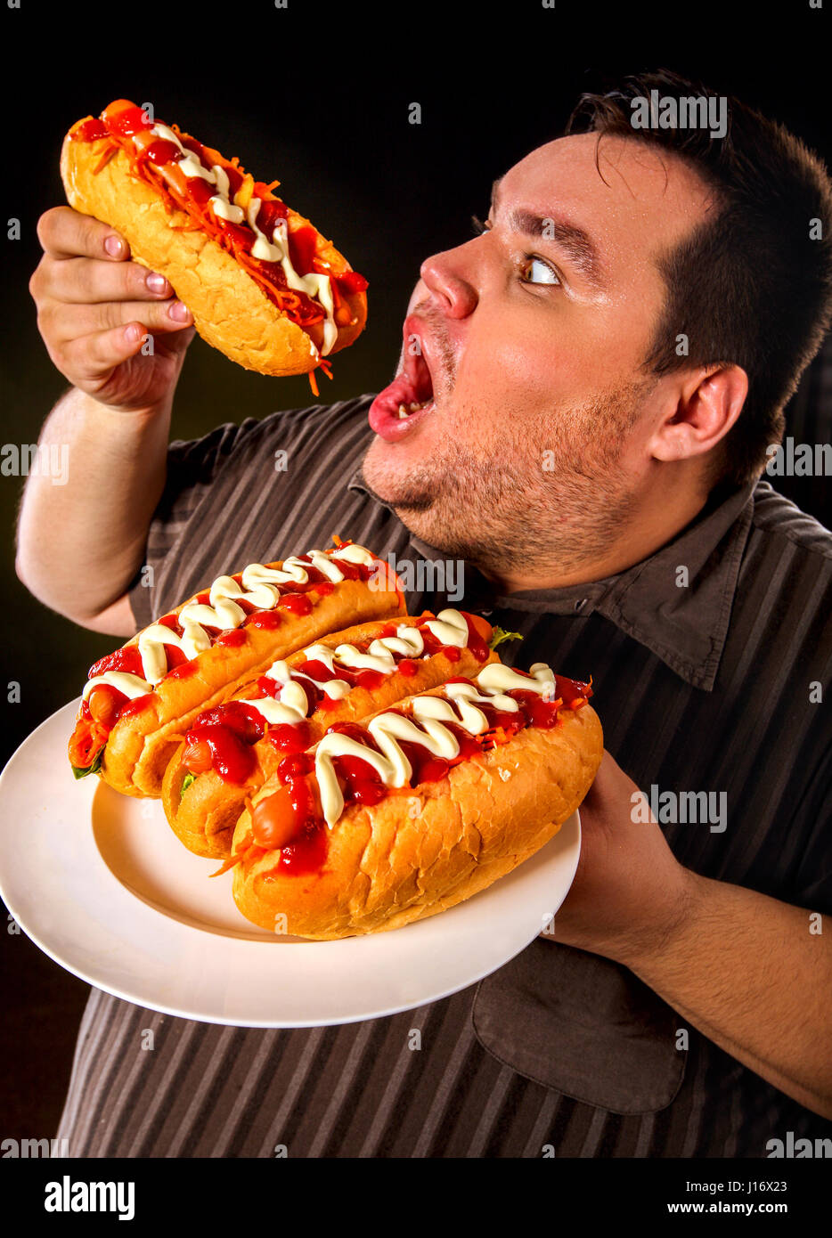 Fat Man Eating Fast Food Hot Dog Breakfast For Overweight Person Stock fat-man-eating-fast-food-hot-dog-breakfast-for-overweight-person-stock