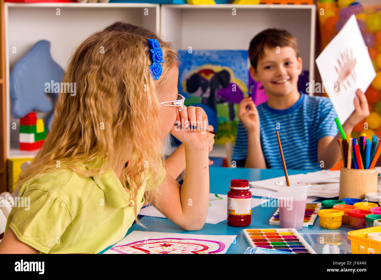 Small students girl and boy painting in art school class Stock Photo ...