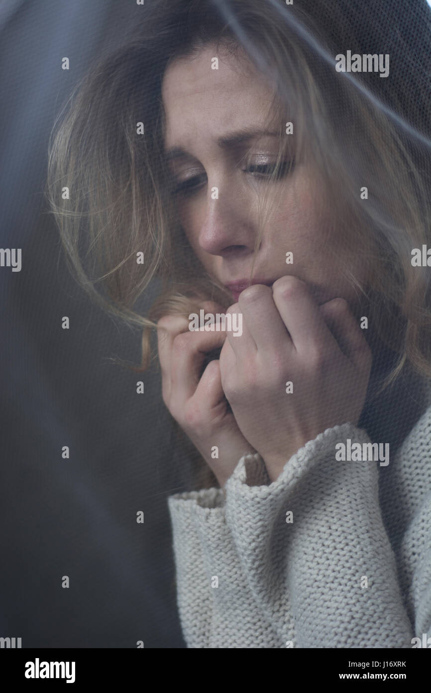 Nervous young woman hands on face Stock Photo - Alamy