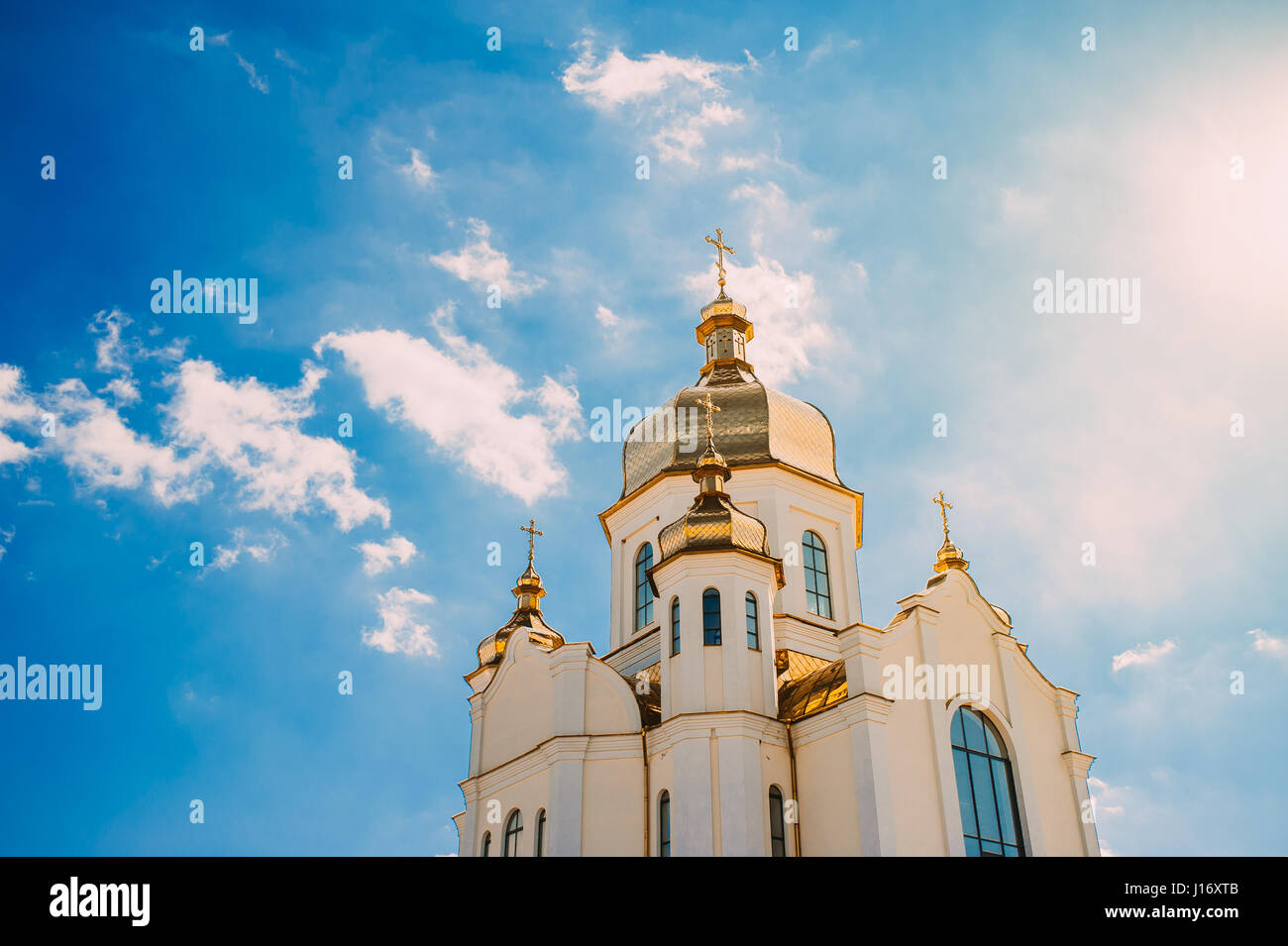 Church with golden domes against a blue sky with clouds Stock Photo - Alamy