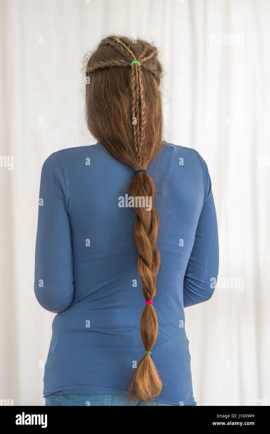 Single plait renaissance hairstyle for long hair. Traditional plait style modelled by girl with very long golden hair Stock Photo