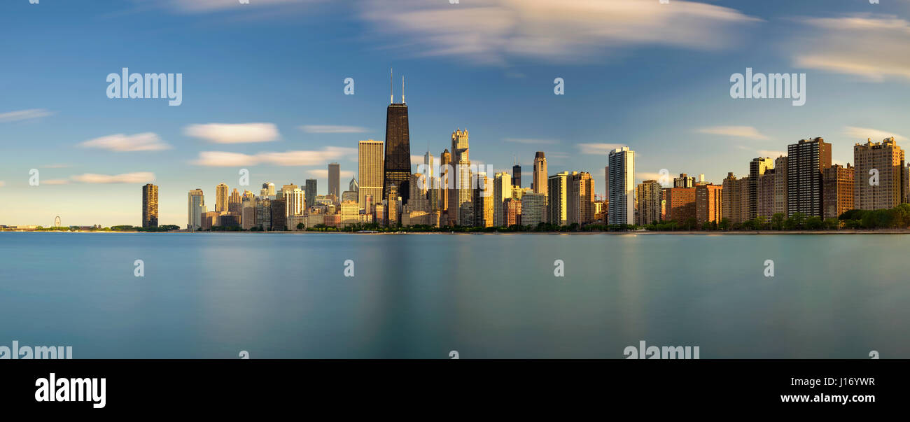 Chicago skyline panorama across Lake Michigan at sunset viewed from North Avenue Beach. Long exposure. Stock Photo