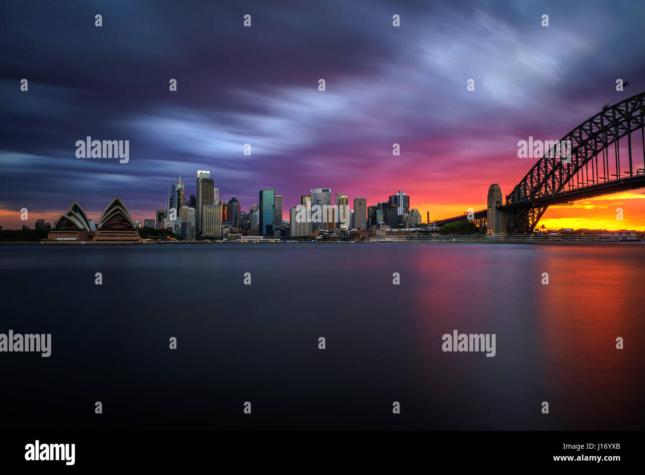 Sunset skyline of Sydney downtown  with Harbour Bridge, NSW, Australia. Long exposure. Stock Photo