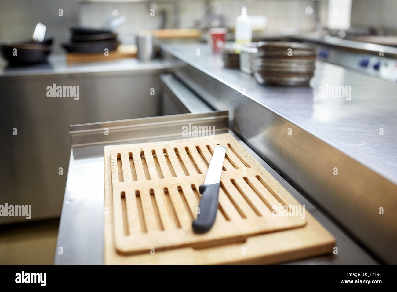 cutting board and knife at restaurant kitchen Stock Photo
