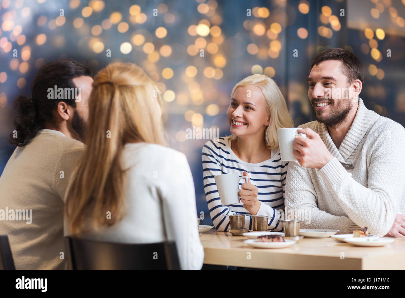 happy friends drinking tea or coffee at cafe Stock Photo - Alamy