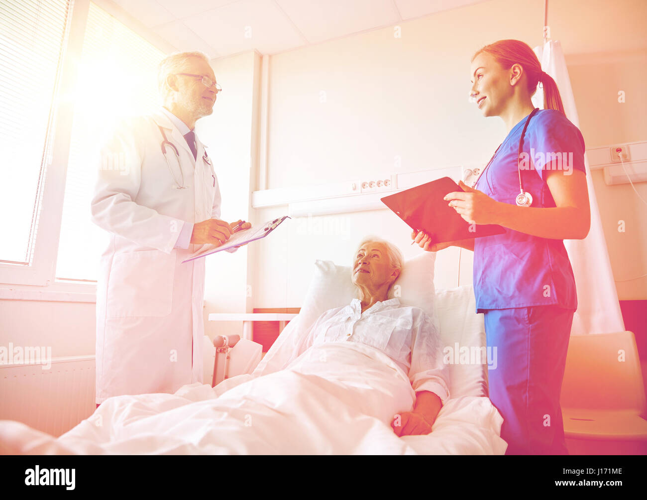 doctor and nurse visiting senior woman at hospital Stock Photo - Alamy