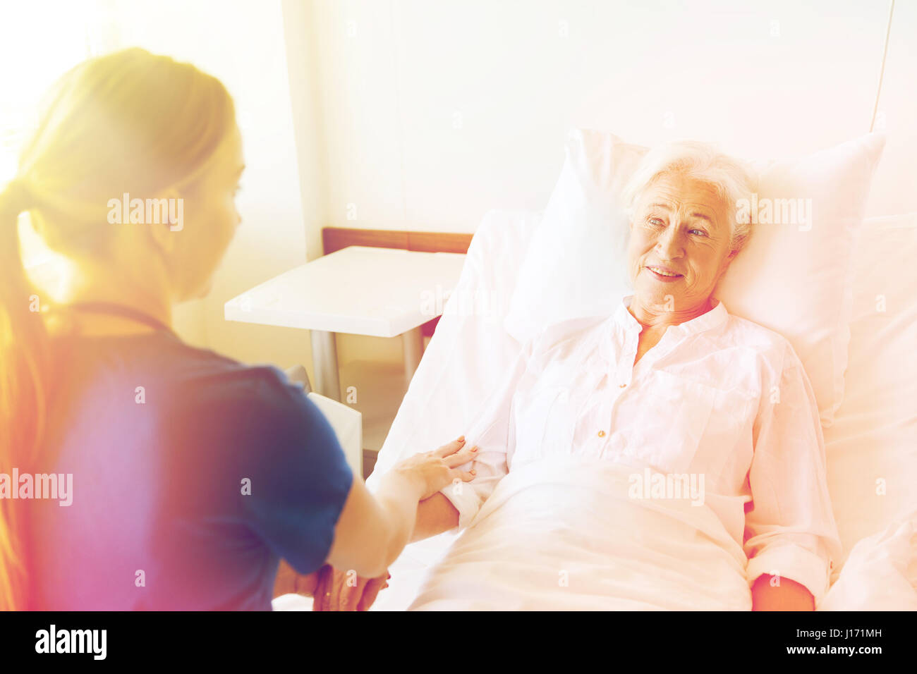 doctor or nurse visiting senior woman at hospital Stock Photo - Alamy