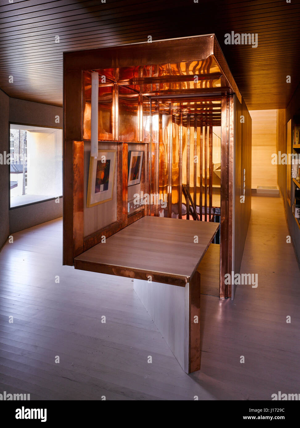 Interior view of copper staircase enclosure showing counter. K House,  Ranelagh, Ireland. Architect: Architects Tom Maher, 2016 Stock Photo - Alamy