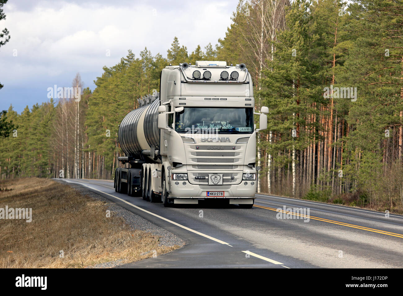 SALO, FINLAND - APRIL 7, 2017: Creamy white super Scania R580 tank truck for bulk transport of Trans Matti Salo moves along highway flanked by forest  Stock Photo