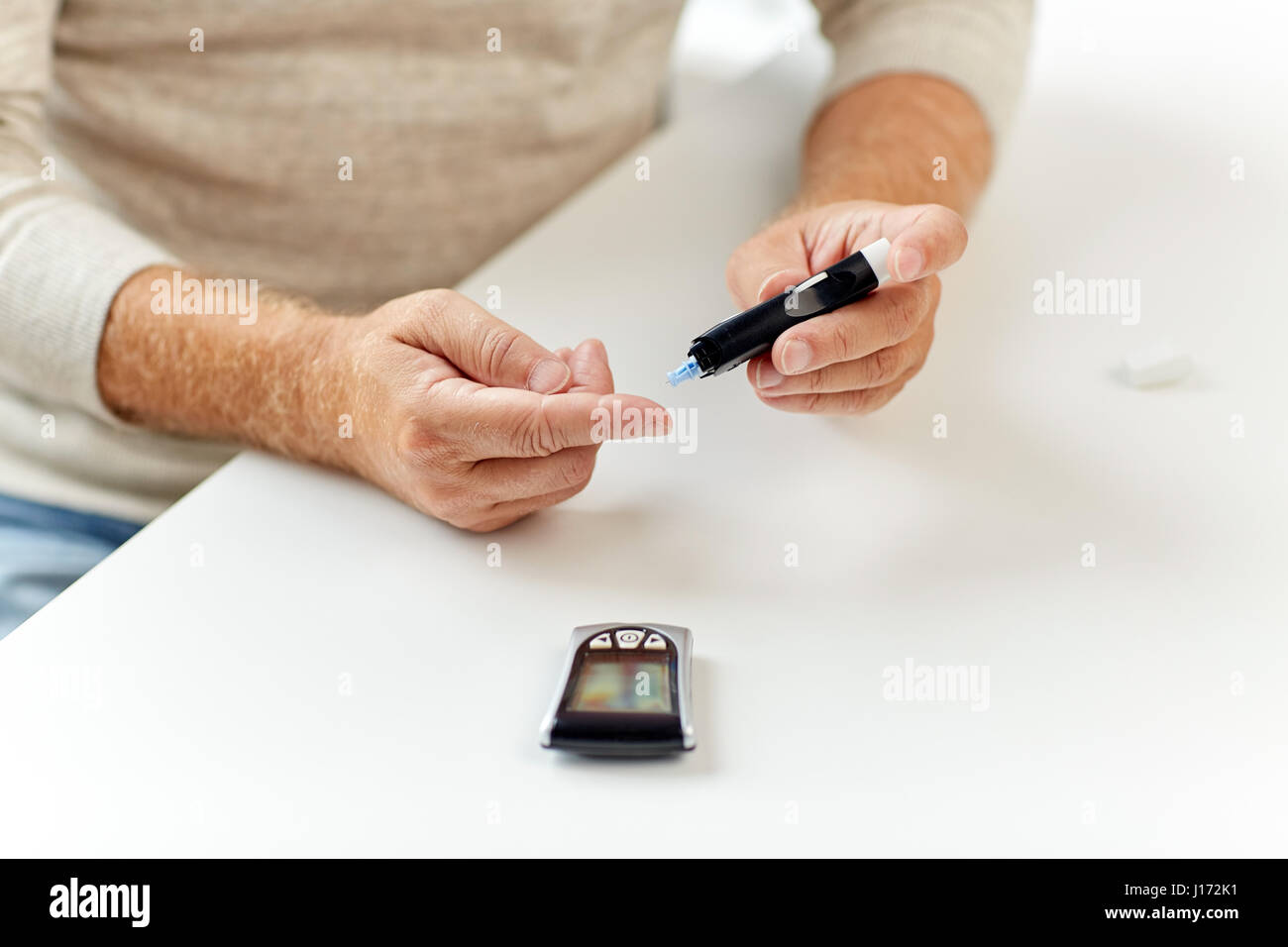 Man Using Glucometer senior man with glucometer checking blood sugar Stock Photo - Alamy