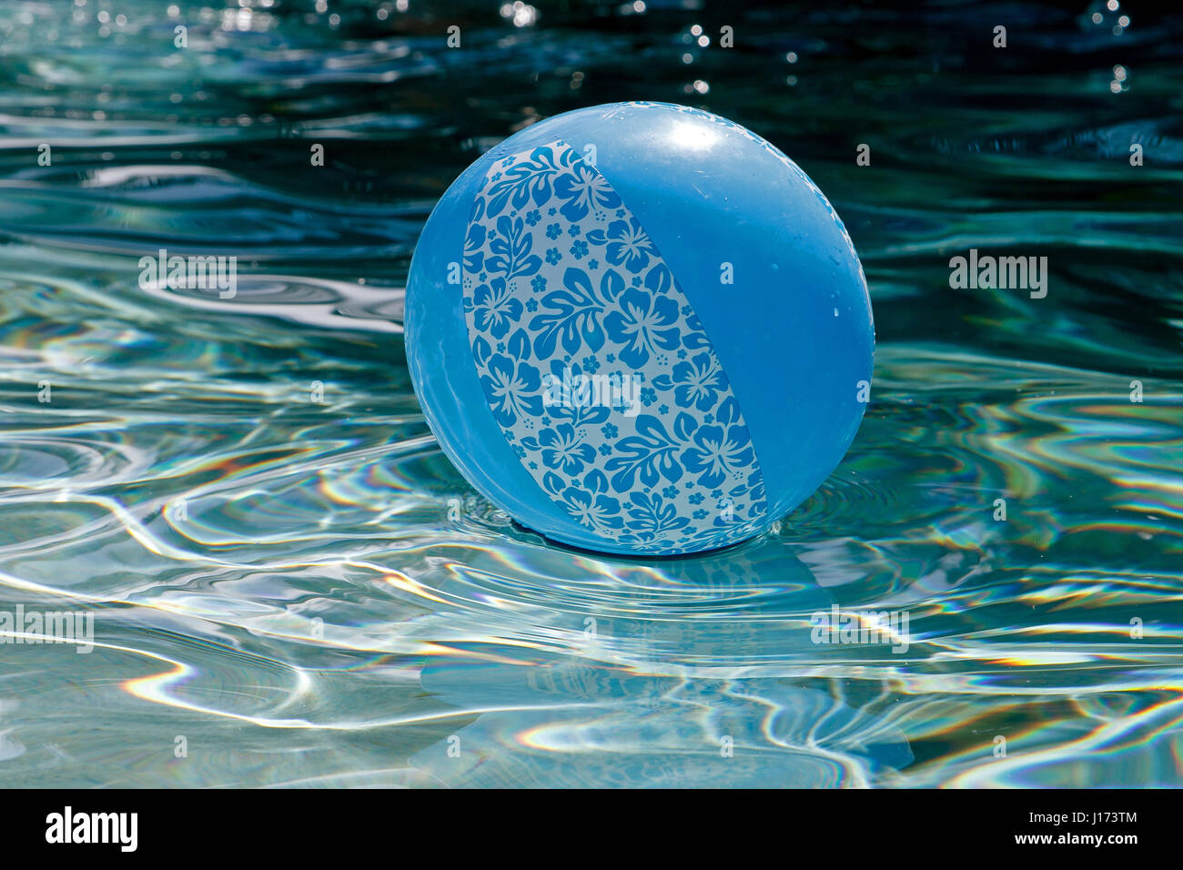 Inflatable blue ball is floating in a pool. Stock Photo