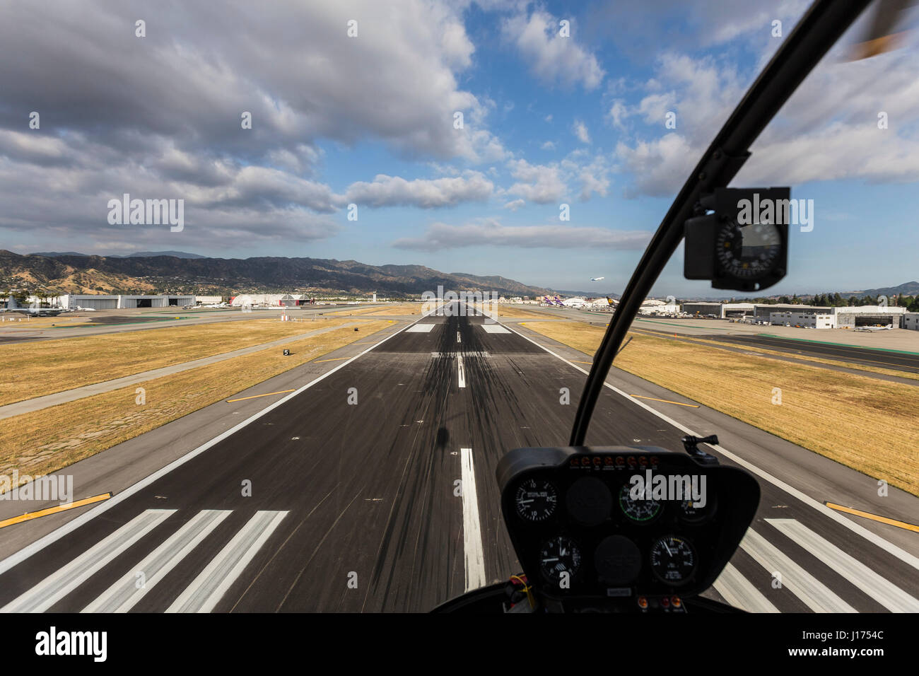 Burbank, California, USA - April 12, 2017:  Runway approach with afternoon clouds in Southern California. Stock Photo
