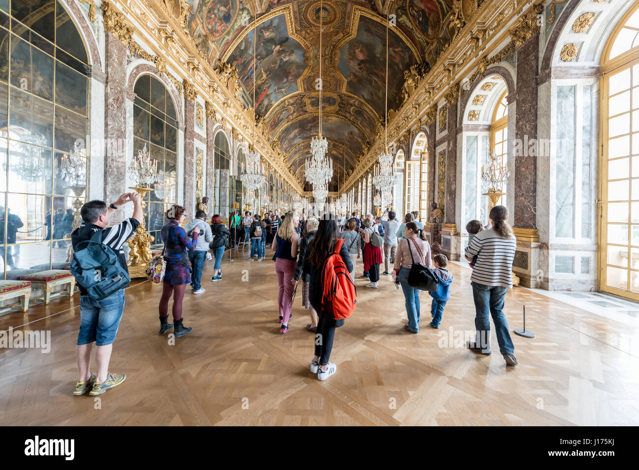 VERSAILLES, FRANCE - May 07, 2016 : Many tourist visiting Hall of Mirrors in Versailles palace in France. Versailles palace is the palace's most celeb Stock Photo