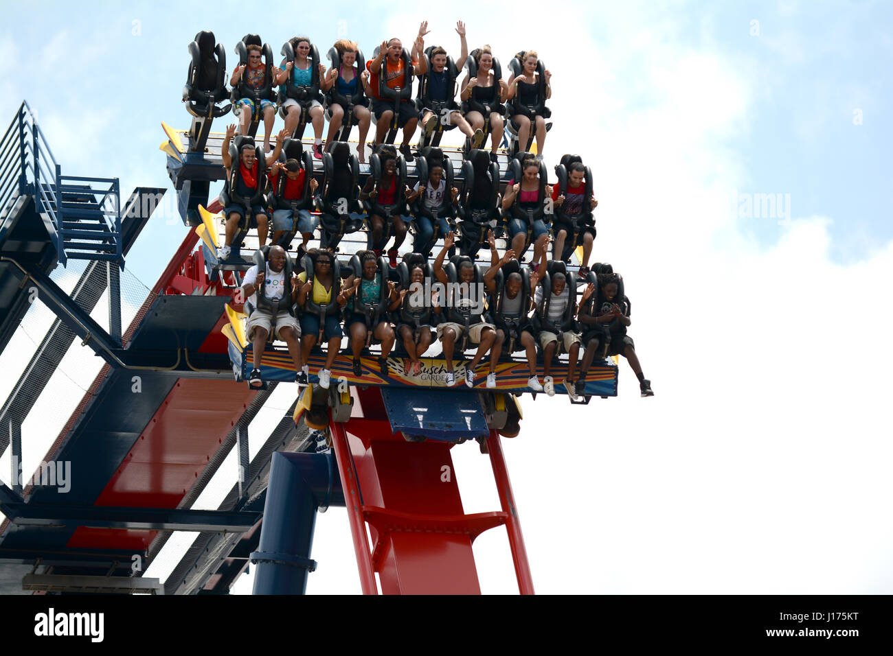 theme park roller coasters full of people wild faces screaming Stock Photo