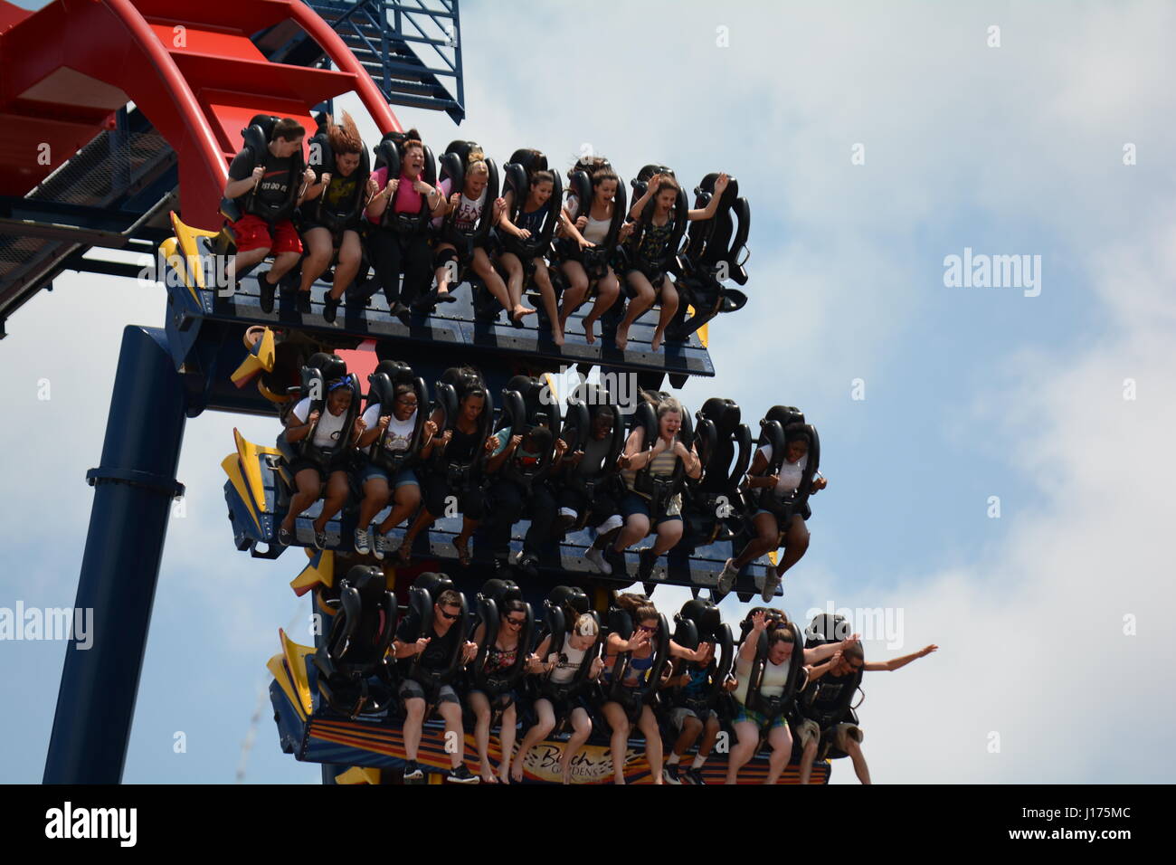 theme park roller coasters full of people wild faces screaming Stock Photo
