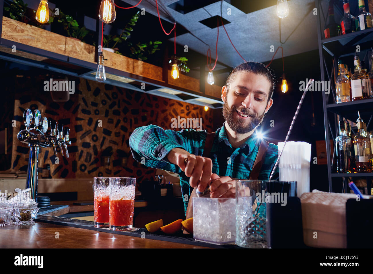 The bartender works at  bar in  restaurant Stock Photo