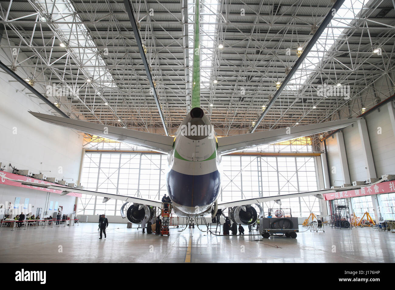 Shanghai. 11th Apr, 2017. Photo taken on April 11, 2017 shows a C919, the first large passenger aircraft designed and built by China, in a hangar in Shanghai, east China. The C919 passed the last expert assessment on Tuesday, its manufacturer announced. Credit: Ding Ting/Xinhua/Alamy Live News Stock Photo