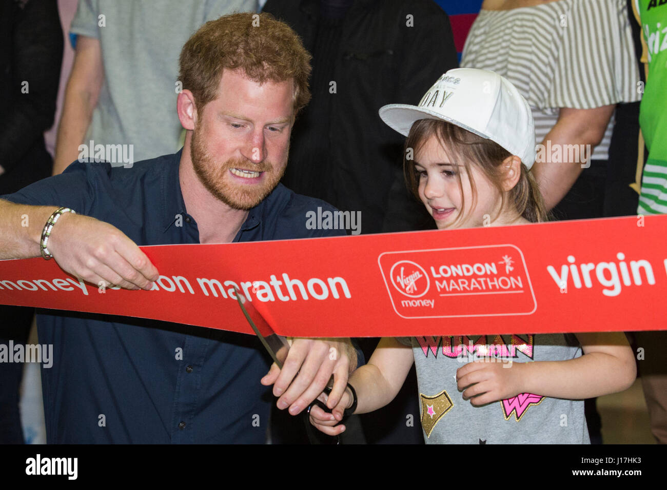 London, UK. 19th Apr, 2017. Prince Harry enlists the help of Melissa Howse, 5, to cut the ribbon. Prince Harry opens the 2017 Virgin Money London Marathon Expo at ExCeL London where thousands of runners will register over the following four days for this Sunday's 37th edition of the race. Prince Harry is Patron of the London Marathon Charitable Trust and, together with The Duke and Duchess of Cambridge, is spearheading the Heads Together campaign to end the stigma around mental health and start a national conversation on mental wellbeing for everyone. Credit: Vibrant Pictures/Alamy Live News Stock Photo