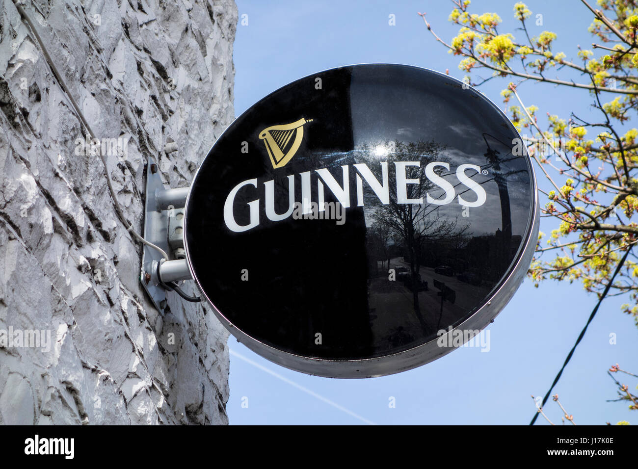 An external hanging sign on an Irish pub advertising Guinness beer Stock Photo