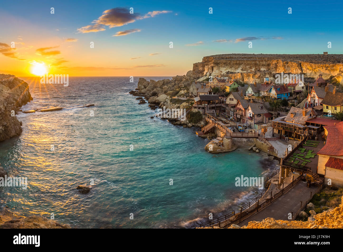 Il-Mellieha, Malta - Panoramic view of the famous Popeye Village at Anchor Bay at sunset Stock Photo