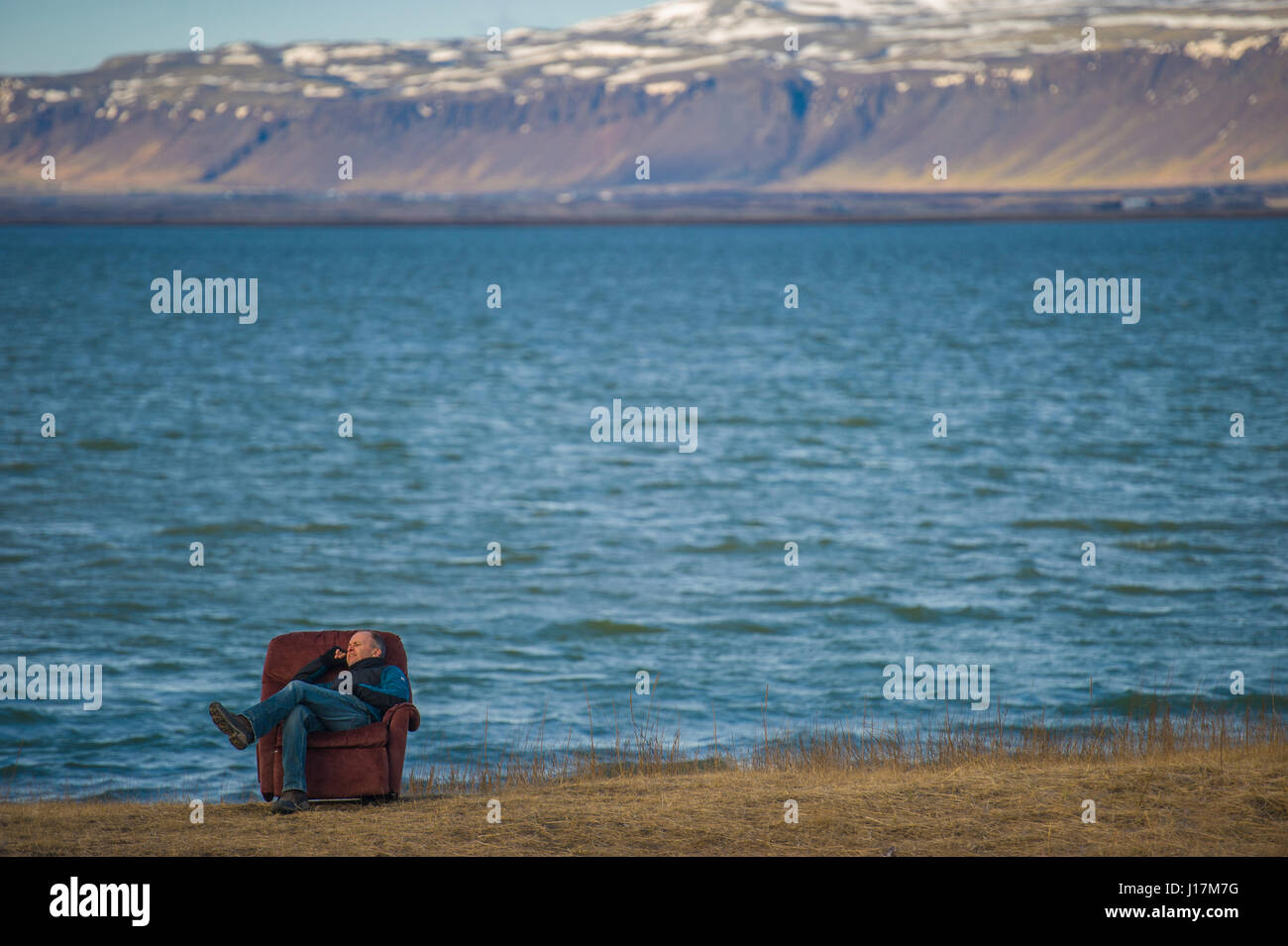 An armchair on the banks of an Icelandic river Stock Photo