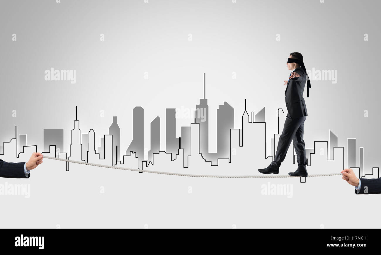 Business concept of risk support and assistance with man balancing on ...