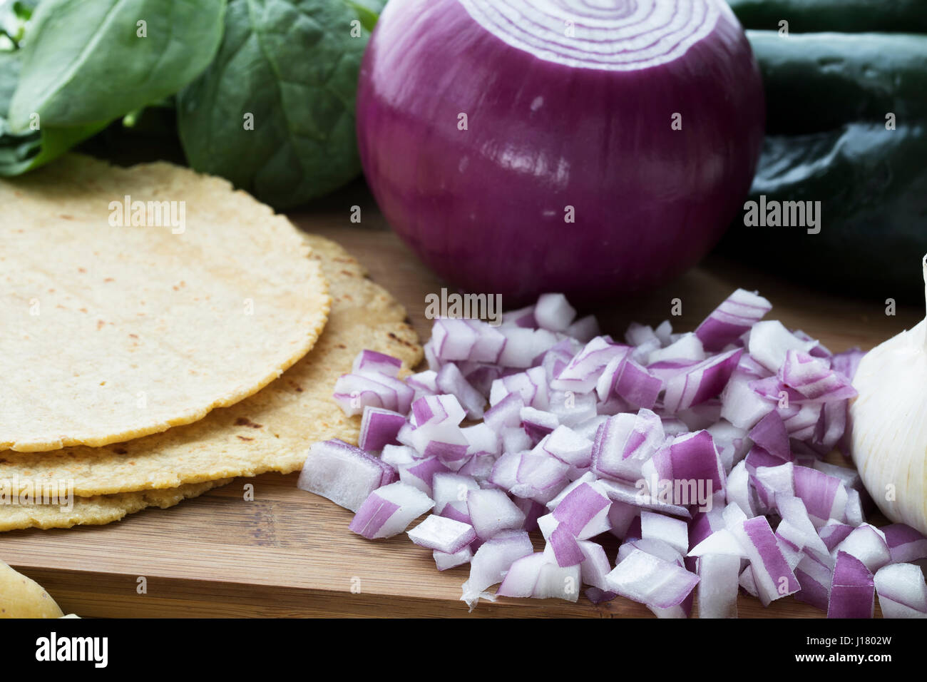 Chopped red onions with corn tortillas and other ingredients. Stock Photo