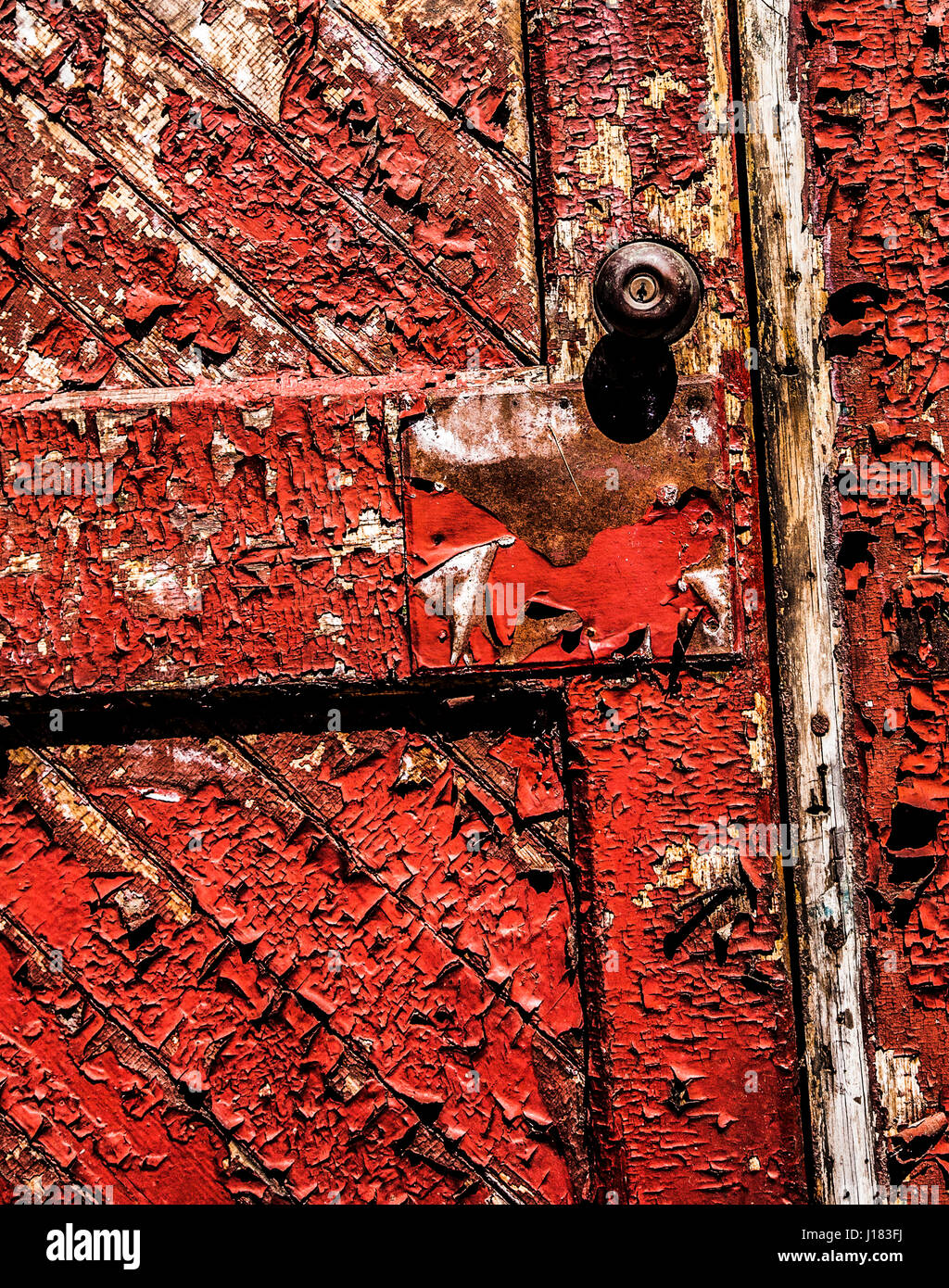Old red colour vintage wooden front door PT abstract with peeling paint, New Jersey, USA, US door knob, behind closed doors, FS 18.82MB 300ppi Stock Photo