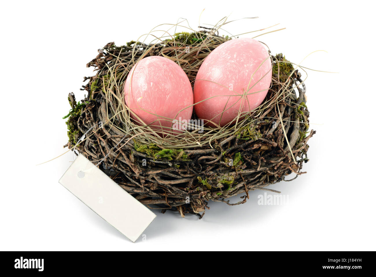 pink easter eggs in a nest with copy space label on white isolated ...