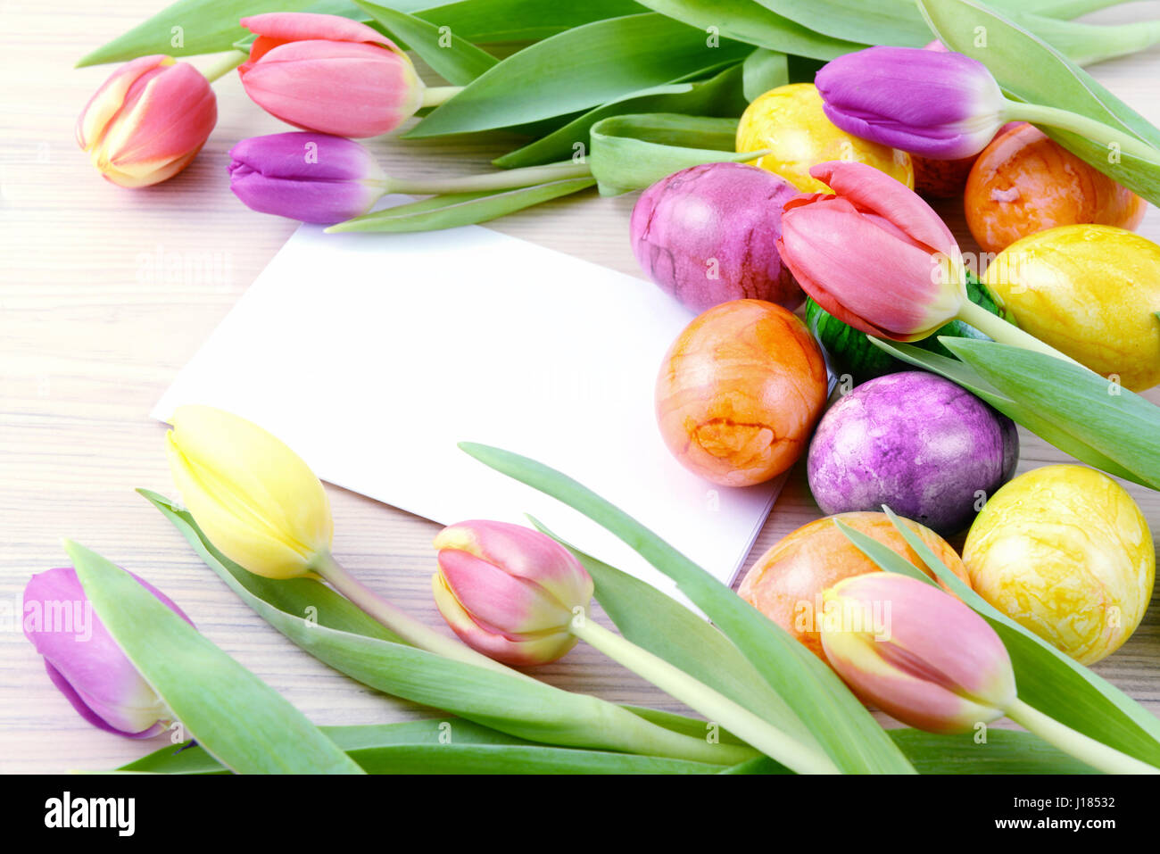 easter eggs and tulips with copy space on beige table background Stock ...