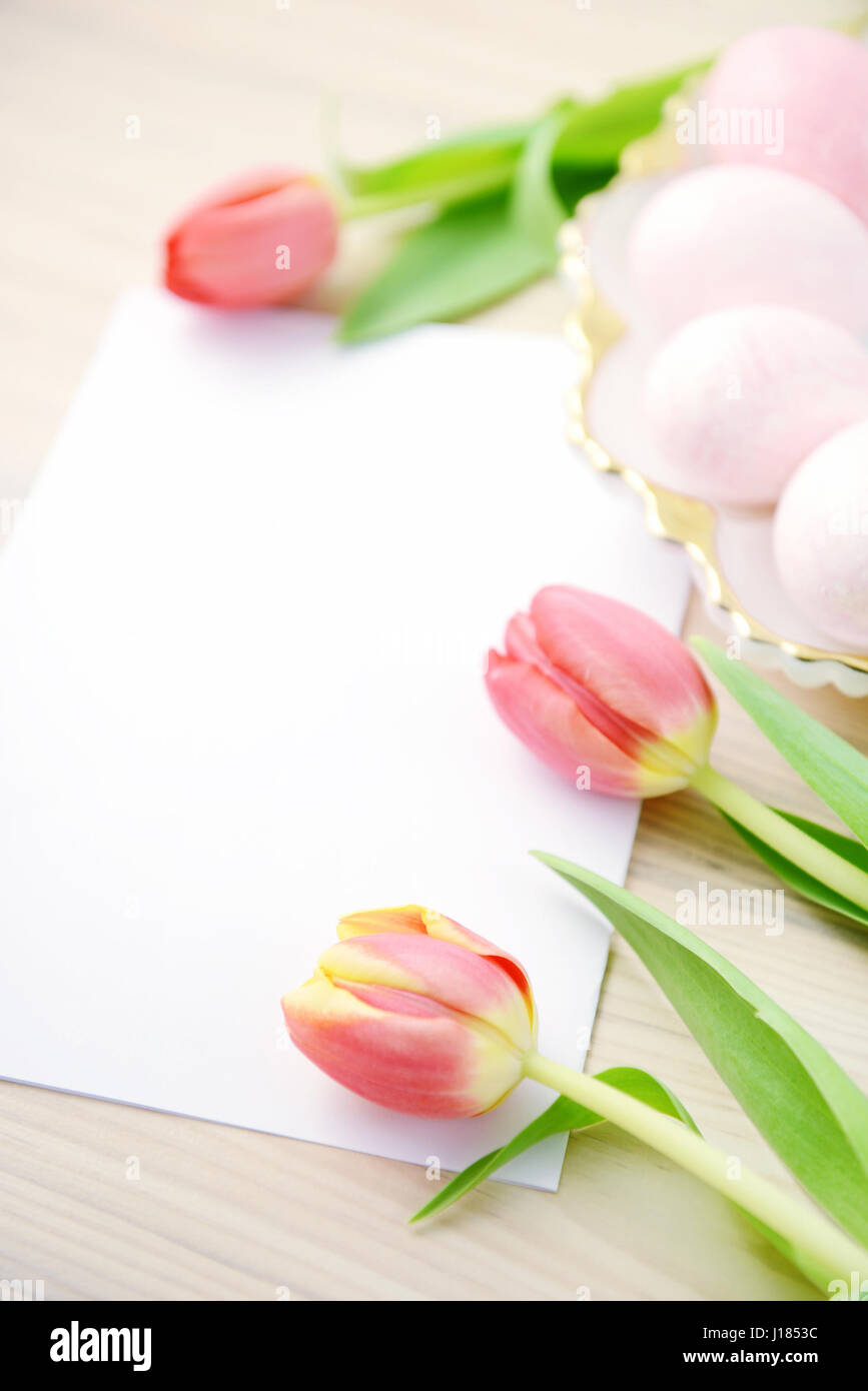 easter eggs and tulips with copy space on beige table background Stock ...