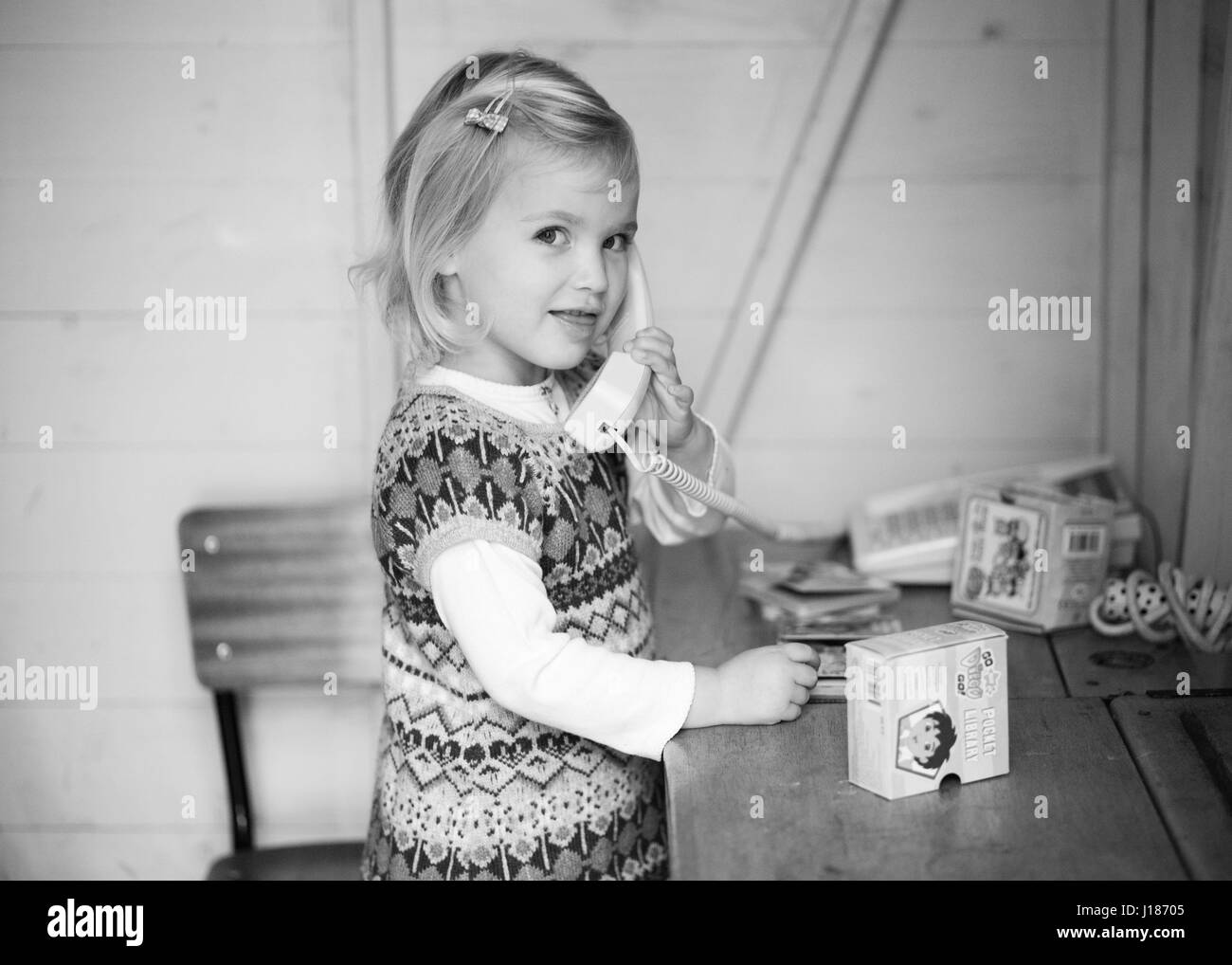 Child on toy telephone Stock Photo