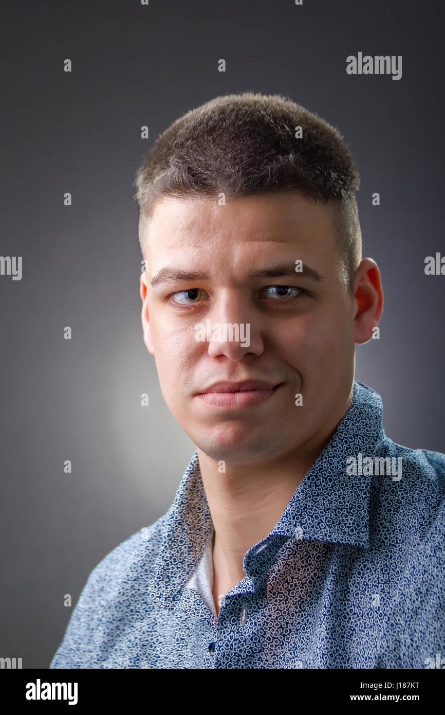 Man in blue shirt wearing hi-res stock photography and images - Alamy