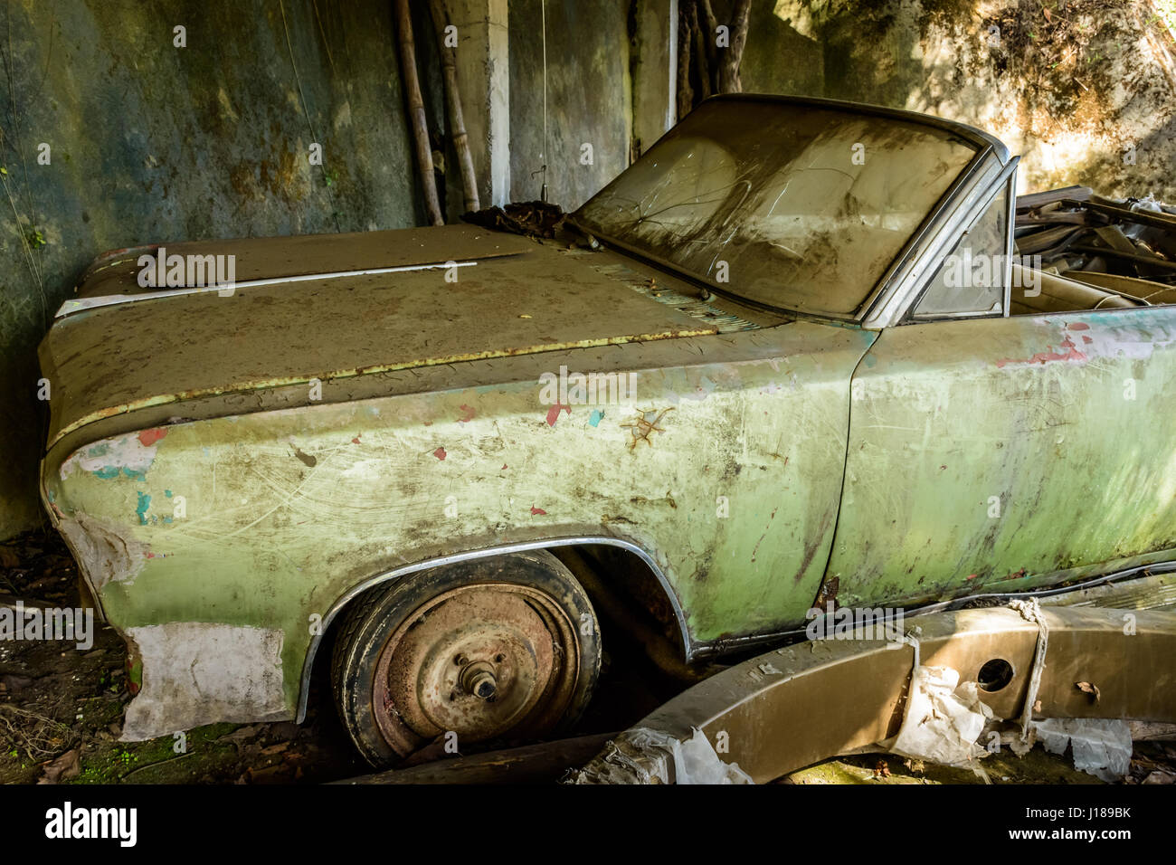 Battered, abandoned, old, green car Stock Photo