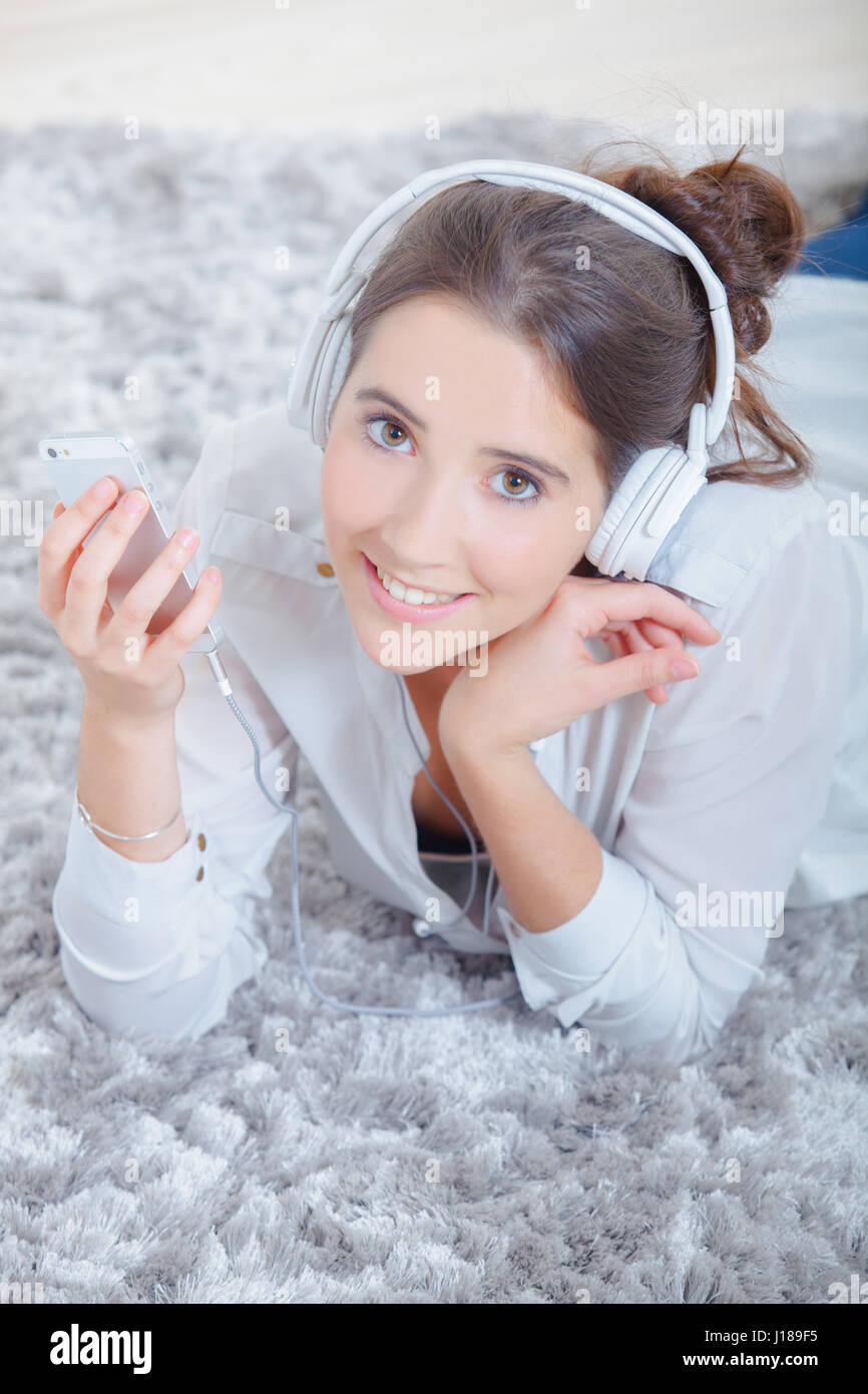 Laying on the floor listening to music Stock Photo - Alamy