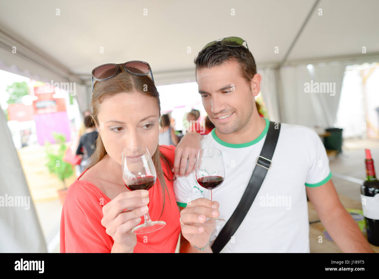 Couple holding glasses of red wine Stock Photo - Alamy