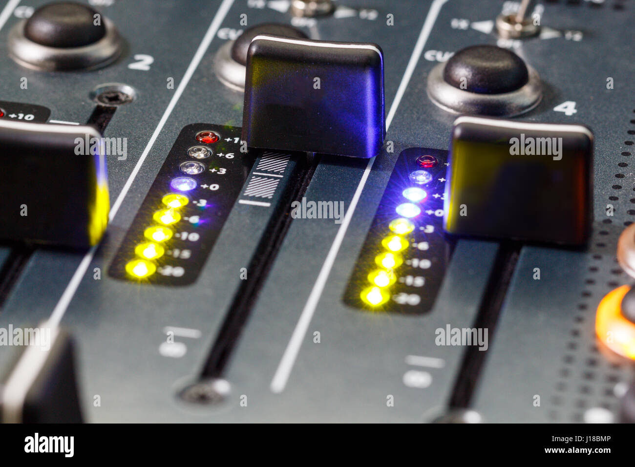 Close up shot of a DJ mixer volume faders Stock Photo