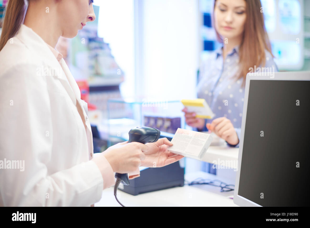 Pharmacist scanning pill box Stock Photo