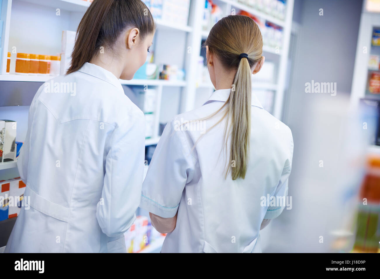 Back view of pharmacists wearing lab coats Stock Photo Alamy