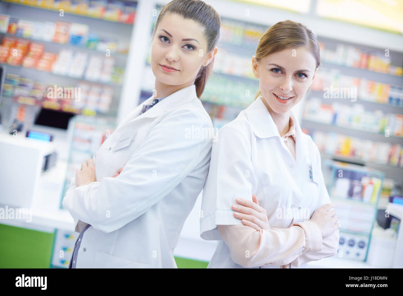 Two attractive pharmacists in pharmacy Stock Photo